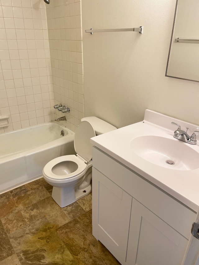 bathroom featuring toilet,  shower combination, and vanity