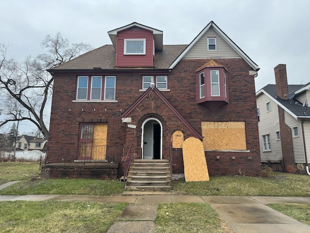 16853 Log Cabin St, Detroit, MI 48203 - view of front of home featuring brick siding, a front yard, and a shingled roof