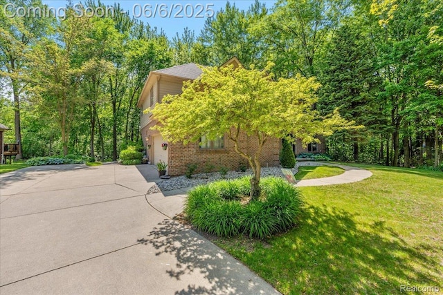 53629 Wayburn Ct, Utica, MI 48315 - view of property exterior with brick siding, driveway, a lawn, and a garage