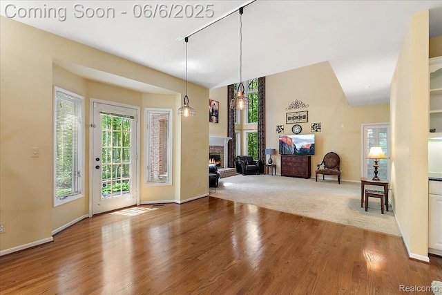 53629 Wayburn Ct, Utica, MI 48315 - foyer entrance with wood finished floors, a brick fireplace, and baseboards