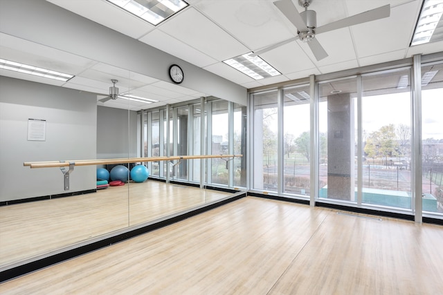 1300 E Lafayette St Unit 1604, Detroit, MI 48207 - workout room with ceiling fan, floor to ceiling windows, wood finished floors, and a drop ceiling