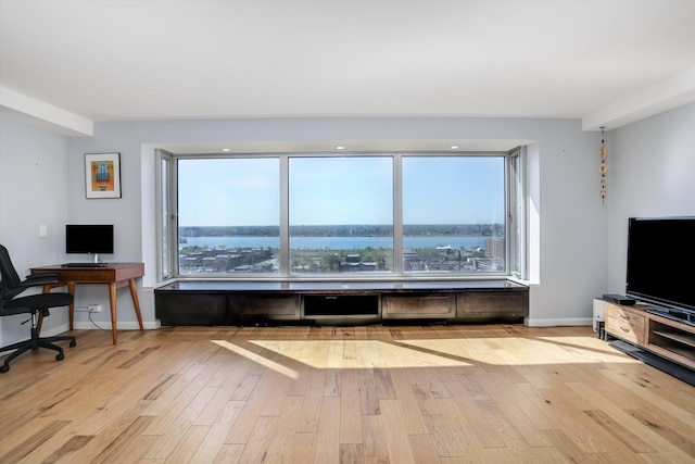1300 E Lafayette St Unit 1604, Detroit, MI 48207 - unfurnished living room featuring hardwood / wood-style floors, an office area, and baseboards