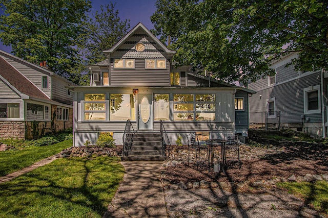 61564 Park St, Cassopolis, MI 49031 - victorian-style house featuring a sunroom, a front yard, and entry steps