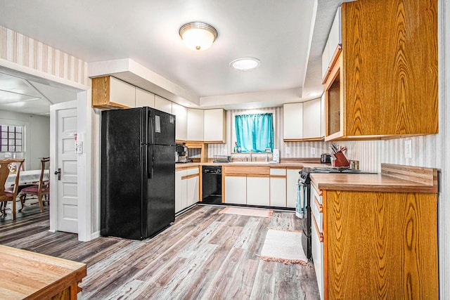 61564 Park St, Cassopolis, MI 49031 - kitchen featuring black appliances, plenty of natural light, white cabinets, and light wood-style flooring