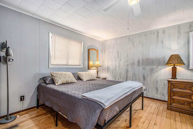 61564 Park St, Cassopolis, MI 49031 - bedroom featuring light wood-style flooring, baseboards, and wood walls