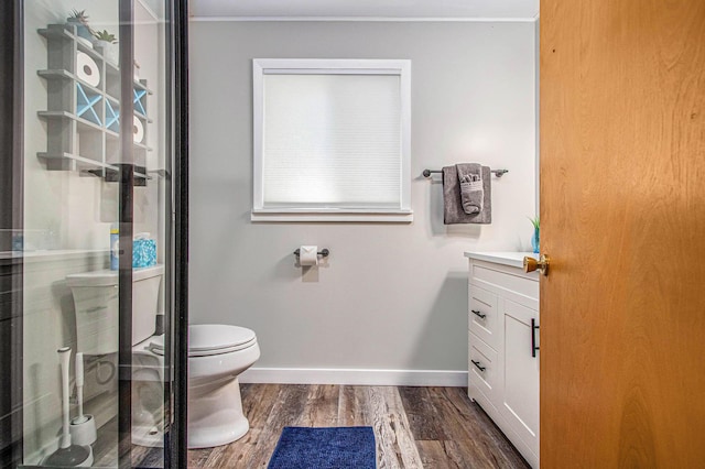 61564 Park St, Cassopolis, MI 49031 - full bathroom featuring wood finished floors, baseboards, vanity, toilet, and a shower with shower door