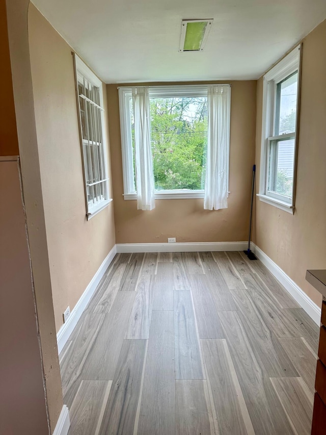 empty room with wood finished floors and baseboards