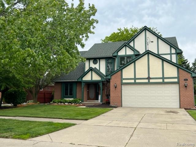 15743 Greenview, Fraser, MI 48026 - english style home featuring a garage, driveway, and brick siding