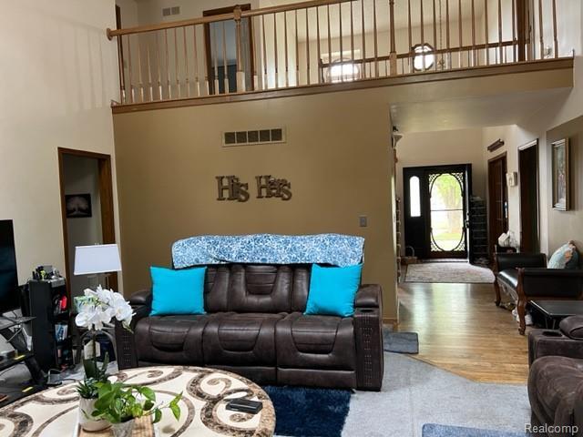 15743 Greenview, Fraser, MI 48026 - carpeted living room with a towering ceiling and wood finished floors