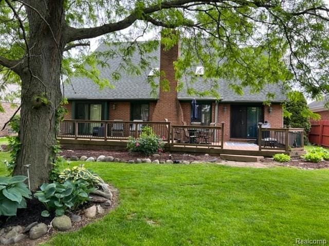 15743 Greenview, Fraser, MI 48026 - back of house with brick siding, a deck, a chimney, and a lawn