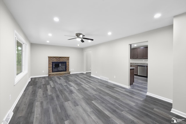 6505 Clover Ln, Lambertville, MI 48144 - unfurnished living room featuring ceiling fan, dark wood-type flooring, recessed lighting, baseboards, and a brick fireplace