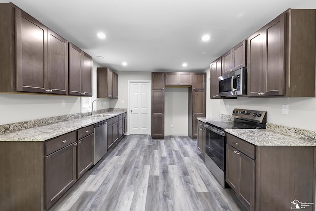 6505 Clover Ln, Lambertville, MI 48144 - kitchen with stainless steel appliances, light wood-type flooring, a sink, recessed lighting, and light stone counters