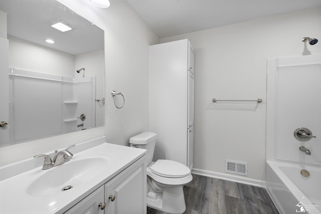 6505 Clover Ln, Lambertville, MI 48144 - full bathroom featuring vanity, shower / bathtub combination, toilet, wood finished floors, and baseboards