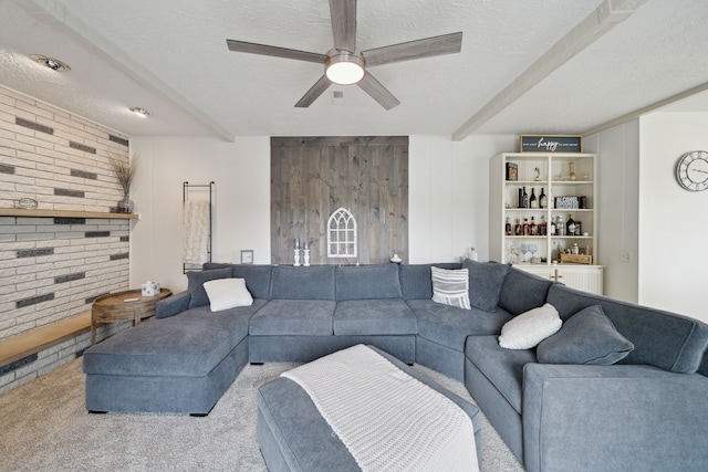 3732 Loch Dr, Highland, MI 48357 - living room with carpet, beamed ceiling, ceiling fan, and a textured ceiling