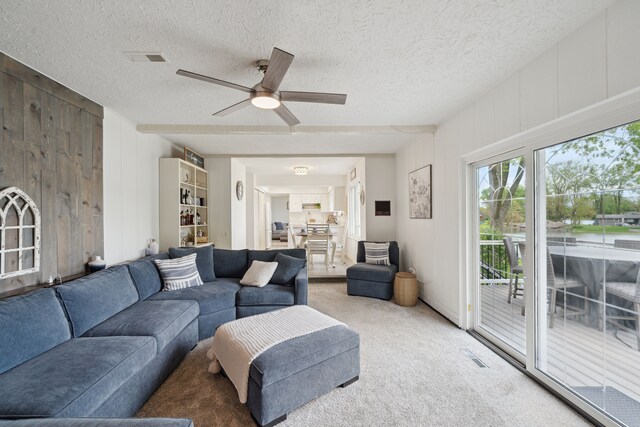 3732 Loch Dr, Highland, MI 48357 - living room featuring ceiling fan, carpet floors, a textured ceiling, and wooden walls