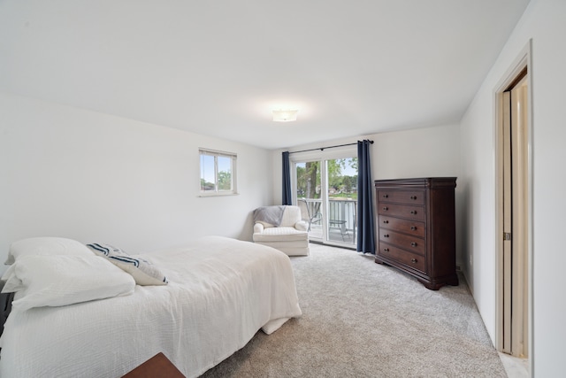 3732 Loch Dr, Highland, MI 48357 - bedroom with access to exterior and light colored carpet