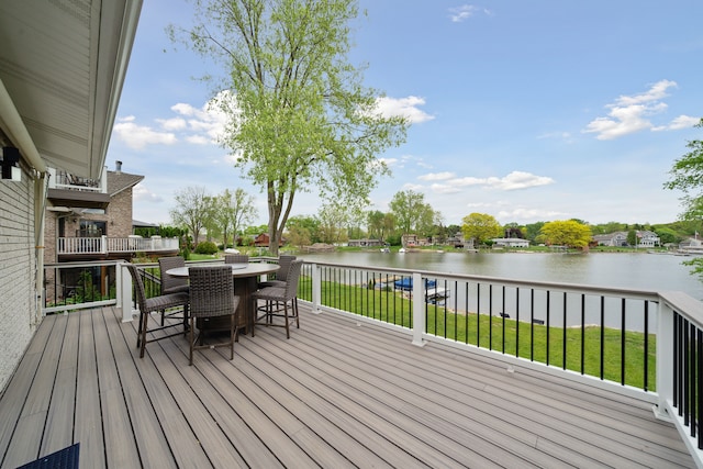 3732 Loch Dr, Highland, MI 48357 - deck with a water view, outdoor dining area, and a lawn