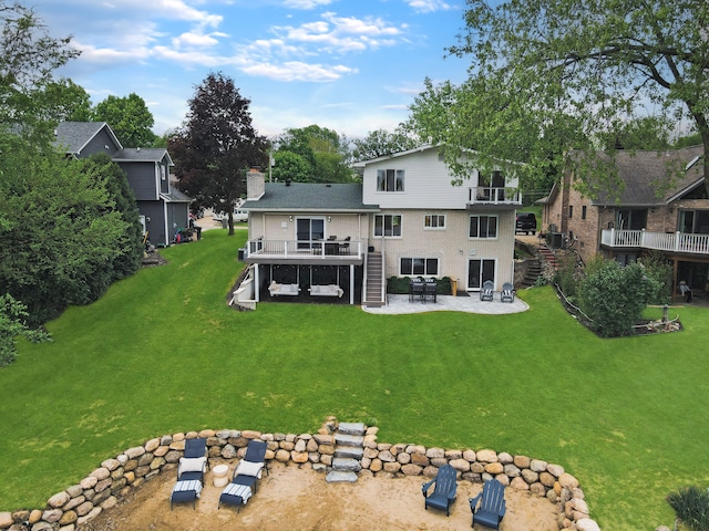 3732 Loch Dr, Highland, MI 48357 - rear view of property with stairs, a patio, a wooden deck, a yard, and a chimney