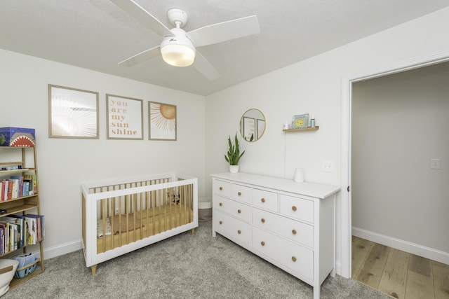 9561 Springville Hwy, Onsted, MI 49265 - bedroom featuring a crib, baseboards, a ceiling fan, and light wood-style flooring