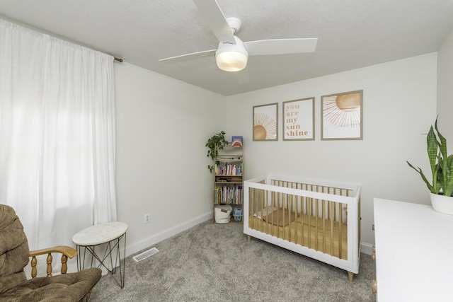 9561 Springville Hwy, Onsted, MI 49265 - carpeted bedroom with baseboards, a nursery area, and ceiling fan