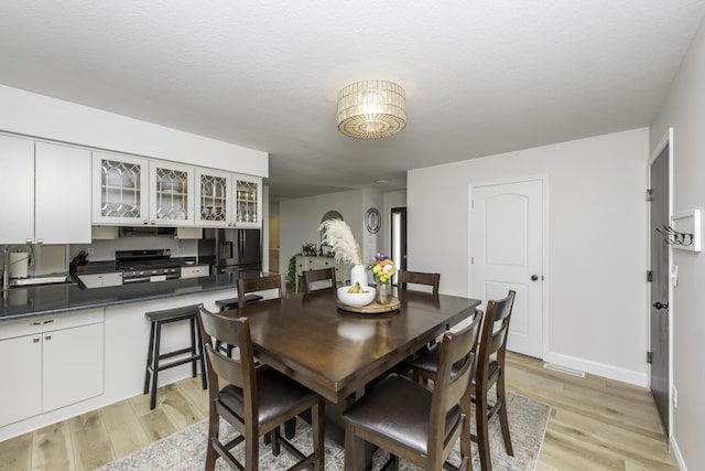9561 Springville Hwy, Onsted, MI 49265 - dining space with light wood-style flooring and baseboards