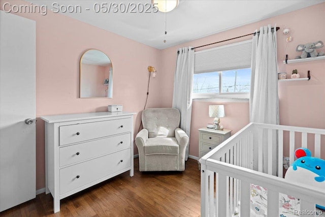771 Easley Dr, Westland, MI 48186 - bedroom featuring a crib, wood finished floors, and baseboards