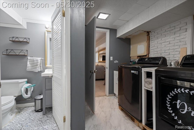 771 Easley Dr, Westland, MI 48186 - laundry room featuring independent washer and dryer, light marble finish floors, and baseboards