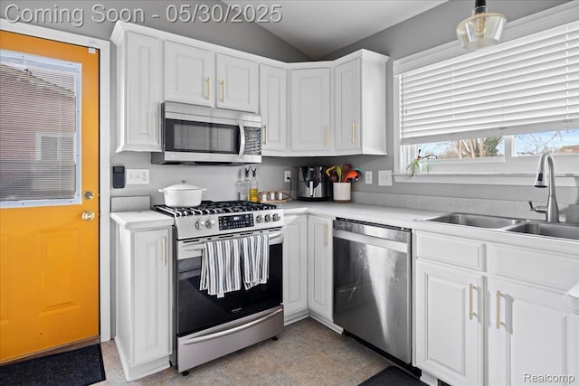 771 Easley Dr, Westland, MI 48186 - kitchen featuring stainless steel appliances, a sink, white cabinets, light countertops, and lofted ceiling