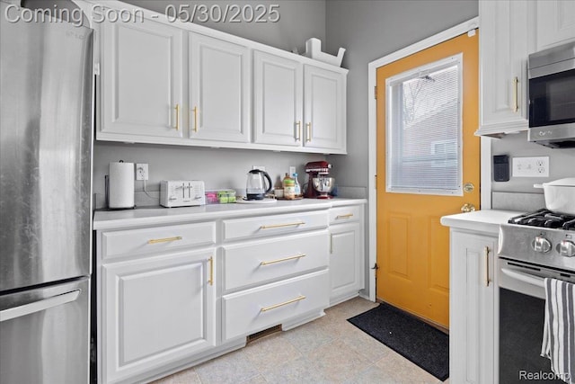 771 Easley Dr, Westland, MI 48186 - kitchen featuring appliances with stainless steel finishes, white cabinetry, and light countertops