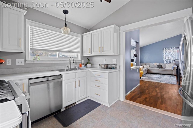 771 Easley Dr, Westland, MI 48186 - kitchen with stainless steel appliances, vaulted ceiling, a sink, white cabinetry, and open floor plan