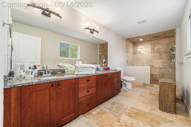 4715 Mandalay Ave, Royal Oak, MI 48073 - bathroom with double vanity, a tile shower, and stone tile flooring