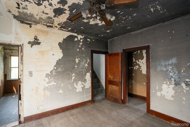 17257 Moenart St, Hamtramck, MI 48212 - spare room with wood finished floors, a ceiling fan, baseboards, and stairs