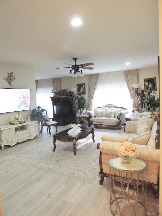 14478 Shadywood Dr, Sterling Heights, MI 48312 - living area with a ceiling fan, wood finished floors, a glass covered fireplace, and recessed lighting