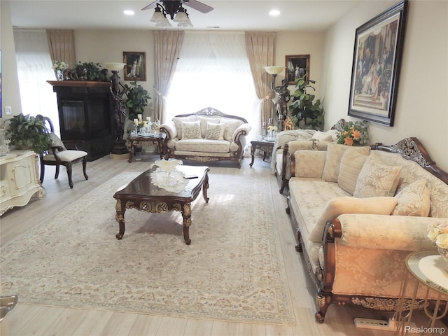 14478 Shadywood Dr, Sterling Heights, MI 48312 - living room featuring ceiling fan, wood finished floors, a glass covered fireplace, and recessed lighting
