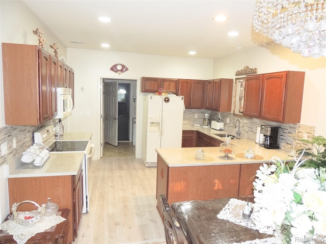 14478 Shadywood Dr, Sterling Heights, MI 48312 - kitchen with white appliances, light countertops, tasteful backsplash, a peninsula, and recessed lighting