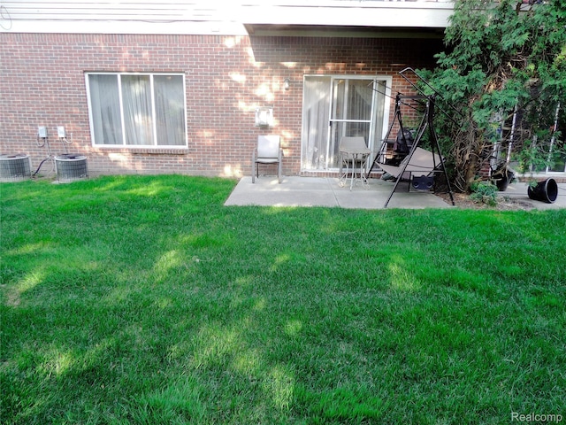14478 Shadywood Dr, Sterling Heights, MI 48312 - back of property featuring brick siding, a patio area, a yard, and central AC unit