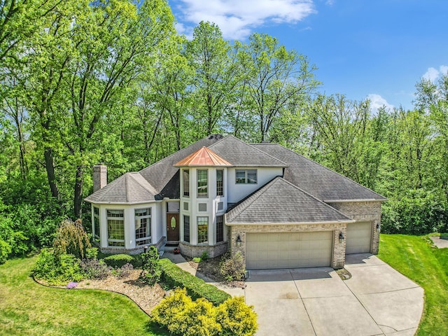 1506 Golfside Ct, Flushing, MI 48433 - view of front of home with an attached garage, roof with shingles, driveway, and a front lawn