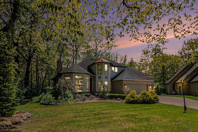1506 Golfside Ct, Flushing, MI 48433 - view of front of property featuring a chimney, a garage, a front yard, and driveway