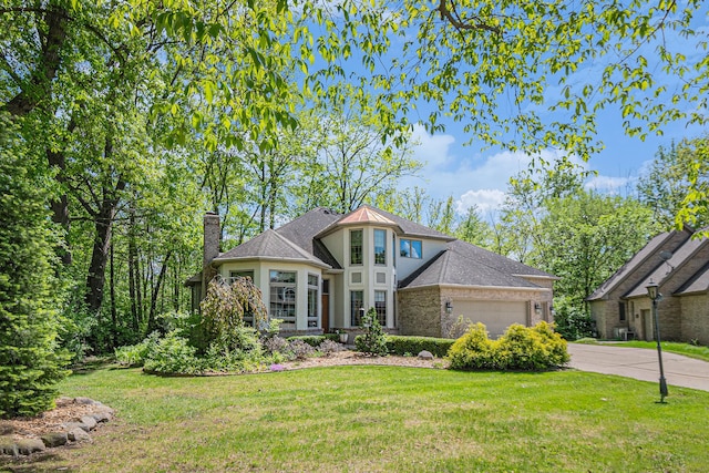 1506 Golfside Ct, Flushing, MI 48433 - view of front facade with an attached garage, a chimney, and a front yard
