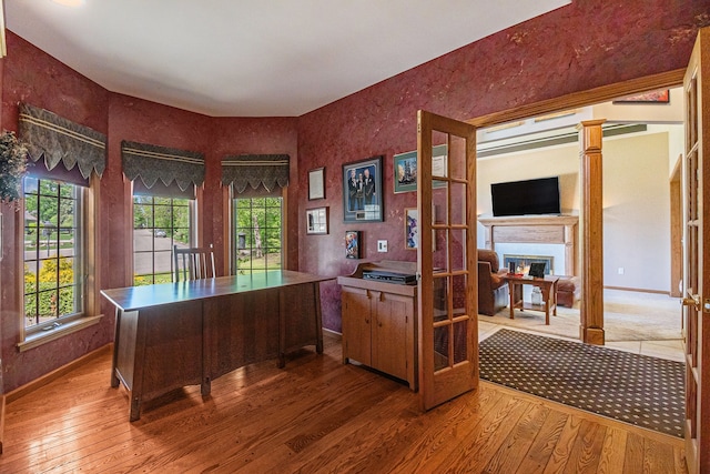 1506 Golfside Ct, Flushing, MI 48433 - office space with hardwood / wood-style floors, a warm lit fireplace, and baseboards