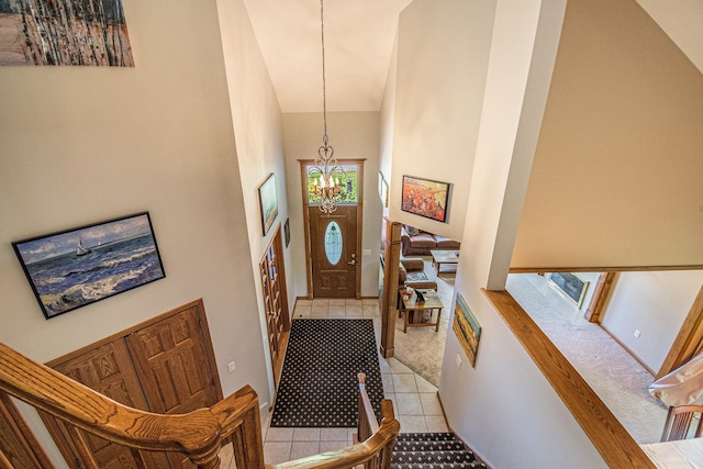 1506 Golfside Ct, Flushing, MI 48433 - entryway with light tile patterned floors, a chandelier, high vaulted ceiling, and healthy amount of natural light