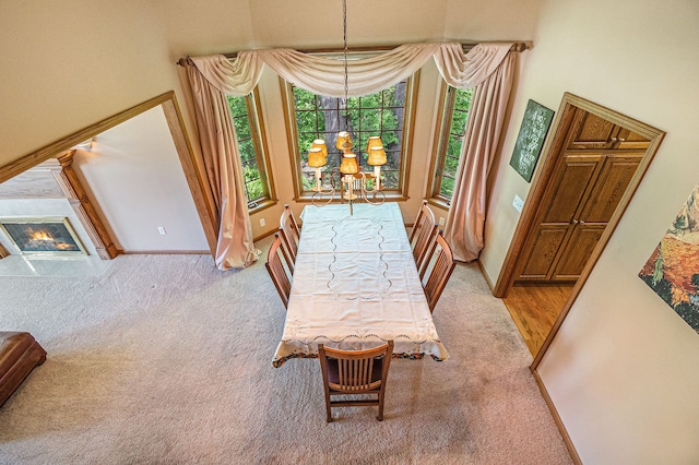 1506 Golfside Ct, Flushing, MI 48433 - carpeted dining space featuring baseboards and a glass covered fireplace