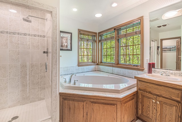 1506 Golfside Ct, Flushing, MI 48433 - bathroom featuring a stall shower, a bath, vanity, and recessed lighting