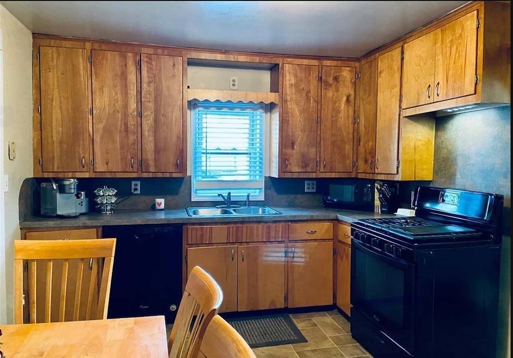 1038 W Pine Ave, Mount Morris, MI 48458 - kitchen featuring black appliances, a sink, brown cabinets, and tasteful backsplash