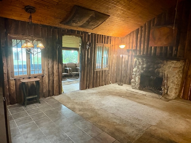 3788 Cedar Point Rd, Howell, MI 48843 - unfurnished living room featuring a fireplace, lofted ceiling, tile patterned flooring, wood walls, and a chandelier