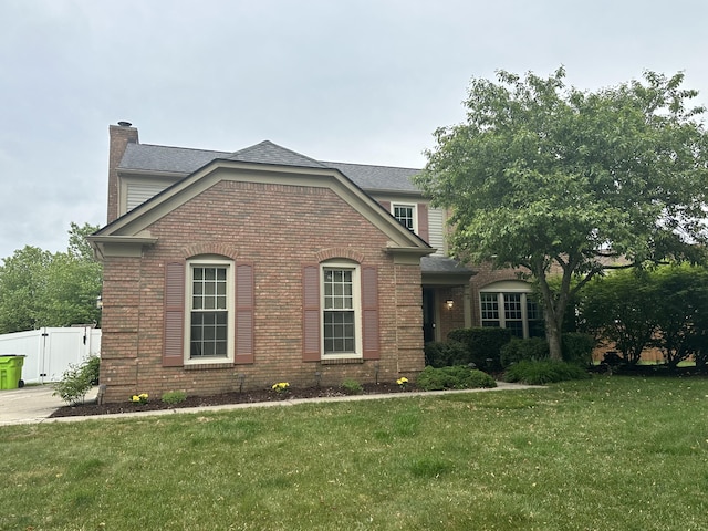 45331 Roundview Dr, Novi, MI 48375 - view of front facade with brick siding, a chimney, and a gate