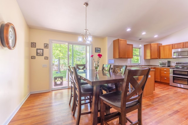 1373 Kristen Path, Saint Joseph, MI 49085 - dining area with light wood finished floors, vaulted ceiling, a chandelier, recessed lighting, and baseboards
