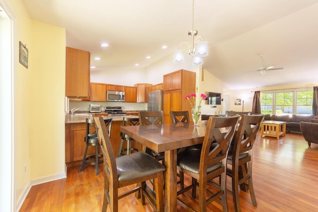 1373 Kristen Path, Saint Joseph, MI 49085 - dining area featuring lofted ceiling, light wood-type flooring, a chandelier, ceiling fan, and baseboards