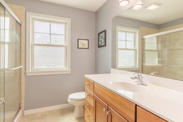 1373 Kristen Path, Saint Joseph, MI 49085 - full bathroom with tile patterned flooring, tiled shower, toilet, vanity, and baseboards
