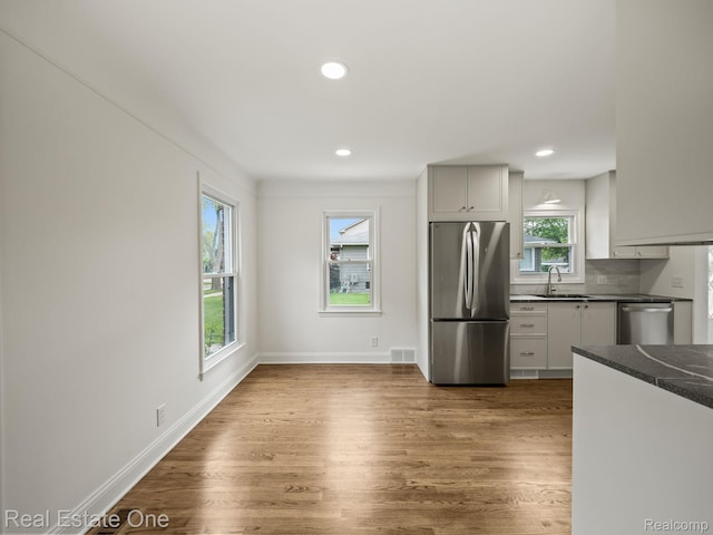 1149 Larkmoor Blvd, Berkley, MI 48072 - kitchen with appliances with stainless steel finishes, dark countertops, dark wood finished floors, recessed lighting, and baseboards
